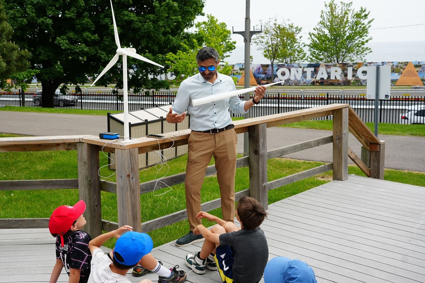 Hassan Shahriar demonstrating wind turbine technology to students